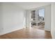 Bright bedroom with hardwood floors and large window offering city views at 3575 Chestnut Pl # 601, Denver, CO 80216