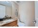 Small half bathroom with granite vanity and toilet at 1099 S Naples Way, Aurora, CO 80017