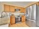 Modern kitchen featuring stainless steel appliances and granite counters at 1099 S Naples Way, Aurora, CO 80017