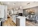 Open concept kitchen with a large island, stainless steel appliances, and hardwood floors at 853 Elm St # 1, Denver, CO 80220