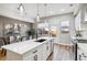 Bright kitchen featuring white cabinets, quartz countertops, and a breakfast bar at 853 Elm St # 1, Denver, CO 80220