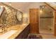 Spa-like bathroom featuring dual sinks, granite countertops, and a walk-in shower at 102 S High St, Breckenridge, CO 80424