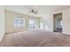 Bright living room with carpeted floors and sliding glass doors at 5620 Tumbleweed Ave, Firestone, CO 80504