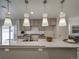 Granite countertop kitchen island with pendant lighting at 13000 E 103Rd Ave, Commerce City, CO 80022