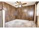 Empty bedroom with wood paneled walls and ceiling fan at 599 Ursula St, Aurora, CO 80011