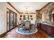 Formal dining room with hardwood floors, chandelier, and access to a patio at 10571 Leonardo Pl, Littleton, CO 80125