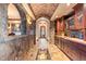 Impressive wine cellar with custom cabinetry and a glass-floored viewing area at 10571 Leonardo Pl, Littleton, CO 80125