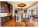 Spacious kitchen with island, stone accents, and hardwood floors at 10571 Leonardo Pl, Littleton, CO 80125