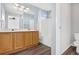 Clean bathroom with double vanity, tub, and wood cabinets at 5241 S Shawnee St, Aurora, CO 80015