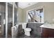Main bathroom with walk-in shower, toilet and modern vanity at 5241 S Shawnee St, Aurora, CO 80015