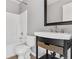 Bathroom with a shower/tub combo, toilet and a vanity with a wicker basket at 5241 S Shawnee St, Aurora, CO 80015