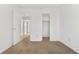 Well-lit bedroom with carpet, closet, and access to the hallway at 5241 S Shawnee St, Aurora, CO 80015