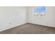 Small bedroom featuring a window and carpet flooring at 5241 S Shawnee St, Aurora, CO 80015