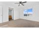 Spacious bedroom featuring a large window with a view and ceiling fan at 5241 S Shawnee St, Aurora, CO 80015