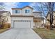 Two-story house with attached garage and landscaped yard at 5241 S Shawnee St, Aurora, CO 80015