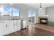 Kitchen with white cabinets, stainless steel appliances, and deck access at 5241 S Shawnee St, Aurora, CO 80015