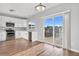 Eat-in kitchen with white cabinets, stainless steel appliances and deck access at 5241 S Shawnee St, Aurora, CO 80015