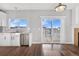 Eat-in kitchen with white cabinets, stainless steel appliances and deck access at 5241 S Shawnee St, Aurora, CO 80015