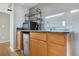 Basement wet bar with sink, microwave, and wood cabinets at 5241 S Shawnee St, Aurora, CO 80015
