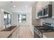Modern kitchen with stainless steel appliances and white cabinets at 2036 S Holly St # 3, Denver, CO 80222