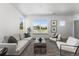 Living room with contemporary furniture, large windows, and a stylish rug at 18633 Stroh Rd # 1-106, Parker, CO 80134