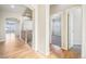 Upstairs hallway with wood floors and access to bedrooms at 6846 S Quantock Way, Aurora, CO 80016