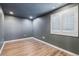 Basement bedroom with gray walls and wood-look flooring at 6846 S Quantock Way, Aurora, CO 80016