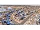 Aerial view of a residential neighborhood in a cul-de-sac with houses and snow at 6846 S Quantock Way, Aurora, CO 80016