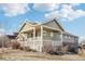 Two-story house with a large front porch and landscaping at 6846 S Quantock Way, Aurora, CO 80016