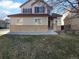 Two-story house with beige siding, red accents, and a landscaped lawn at 12334 Nate Cir, Parker, CO 80134