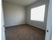 Simple bedroom with brown carpet and a large window at 22975 E Ontario Dr # 106, Aurora, CO 80016