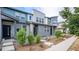 Modern townhome exterior with gray and teal siding, landscaping, and walkway at 16231 E Warner Pl, Denver, CO 80239