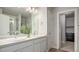Bathroom with double sinks, large mirror, and walk-in closet at 16231 E Warner Pl, Denver, CO 80239