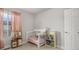 bedroom with bed, bookshelf, and toys at 16231 E Warner Pl, Denver, CO 80239