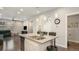 Kitchen island with granite countertop, double sink, and seating for three at 16231 E Warner Pl, Denver, CO 80239