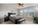 Cozy bedroom with a queen bed, a black headboard, and a ceiling fan at 16231 E Warner Pl, Denver, CO 80239
