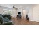 Spacious living room with hardwood floors, a green sectional sofa, and a ceiling fan at 16231 E Warner Pl, Denver, CO 80239