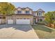 Brick home with three-car garage and landscaped yard at 20816 E Shefield Pl, Parker, CO 80138