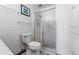 Bathroom with shower, toilet and white tiled walls at 650 S Alton Way # 5D, Denver, CO 80247