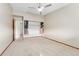 Bright bedroom with carpeted floor, ceiling fan, and large closet at 650 S Alton Way # 5D, Denver, CO 80247