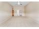 Bedroom with ceiling fan, carpet, and access to closet and bathroom at 650 S Alton Way # 5D, Denver, CO 80247
