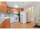 Kitchen features wood cabinets, white appliances, and light countertops at 650 S Alton Way # 5D, Denver, CO 80247