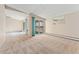 Open living room with access to a balcony and carpeted floors at 650 S Alton Way # 5D, Denver, CO 80247