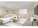 Virtually staged living room featuring L-shaped sofa and wood coffee table at 650 S Alton Way # 5D, Denver, CO 80247