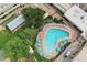 Aerial view of a community pool with surrounding lounge chairs and umbrellas at 650 S Alton Way # 5D, Denver, CO 80247