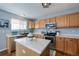 Kitchen with light wood cabinets, stainless steel appliances, and island at 17606 Hoyt Pl, Parker, CO 80134