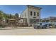 Exterior view of a commercial building with outdoor seating and parked vehicles at 320 Paloma Way, Elizabeth, CO 80107