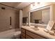 Clean bathroom with a bathtub, shower, and updated vanity at 690 S Alton Way # 1C, Denver, CO 80247
