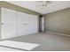 Bedroom with mirrored closet doors and neutral walls at 690 S Alton Way # 1C, Denver, CO 80247