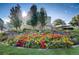Charming courtyard with colorful flowers and a central fountain at 690 S Alton Way # 1C, Denver, CO 80247